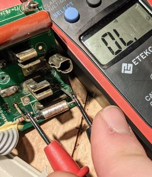 Multimeter checking the current across the fuse, showing that the fuse is blown No current!